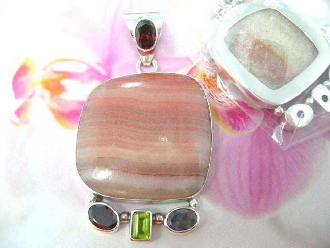 Balinese fashion wear jewelry wholesaler imports crafted 925. sterling silver pendant with large gemstone center and four decorative crystals