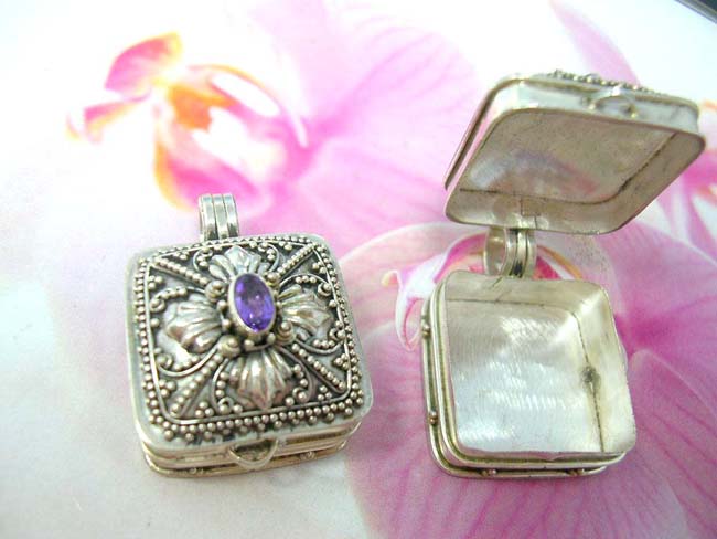 International bali jewelry outlet. Amethyst crystal embedded in 925. sterling silver locket decorated in bead and flower design 