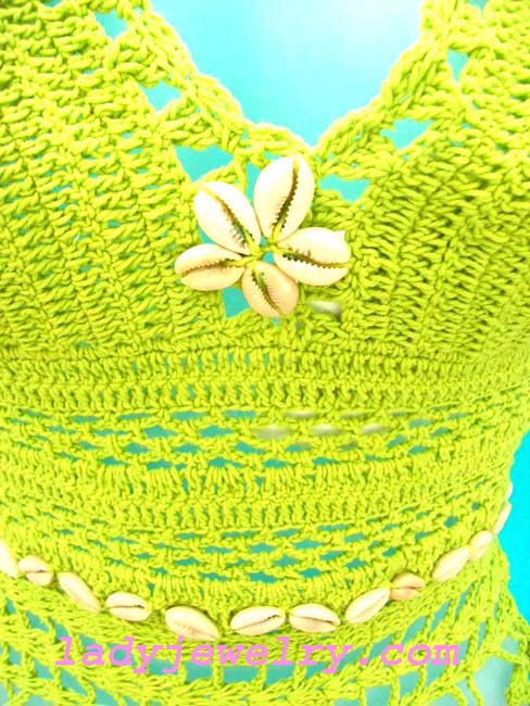 Vacation club clothing store. Ladies trendy crochet fashion top with seashell waist decor and center crest 