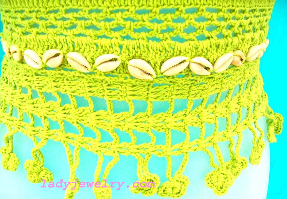 Vacation club clothing store. Ladies trendy crochet fashion top with seashell waist decor and center crest 
